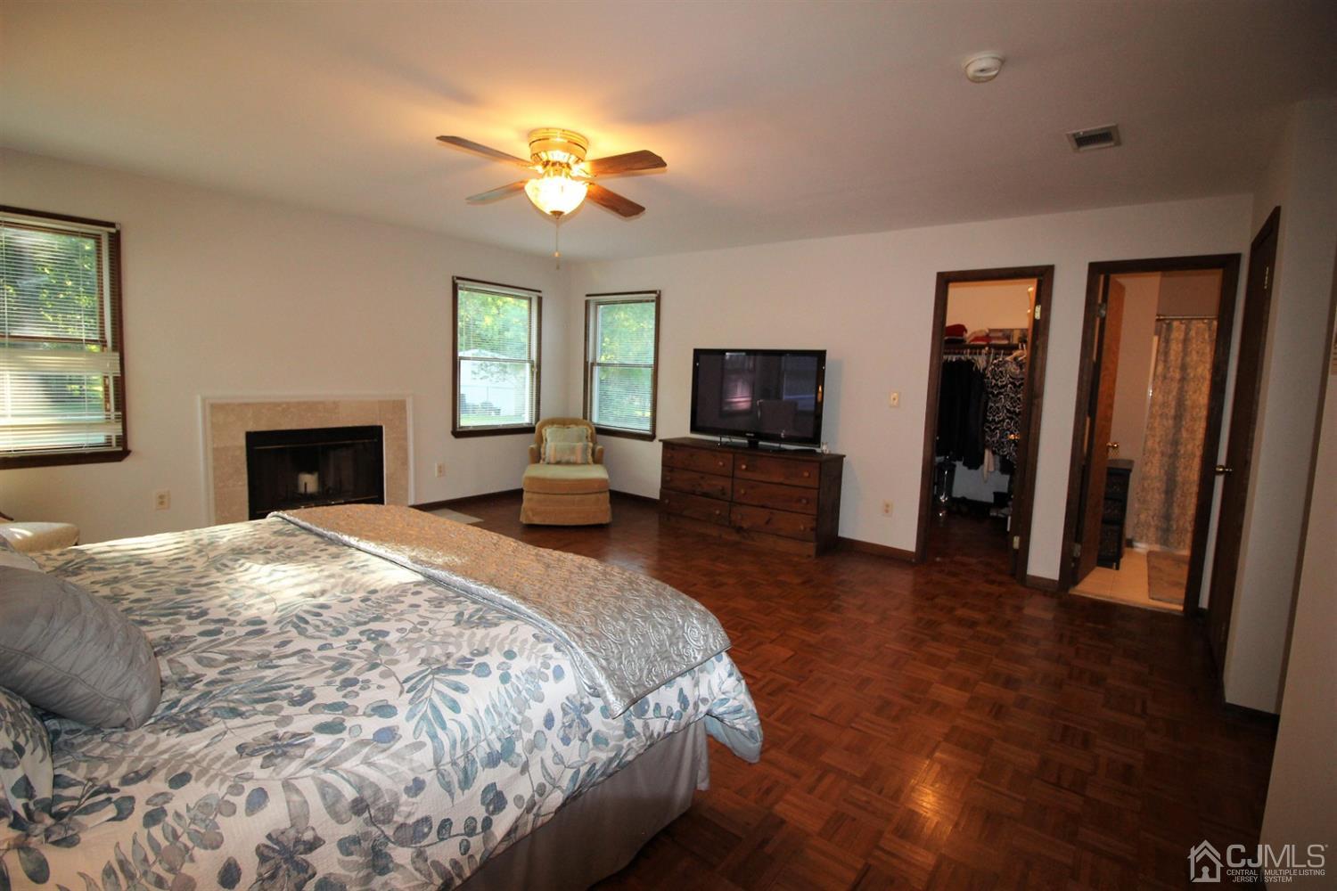 26 Homestead Road Edison, NJ 08820 - Photo 24 of 34 a spacious bedroom with a bed and a chandelier
