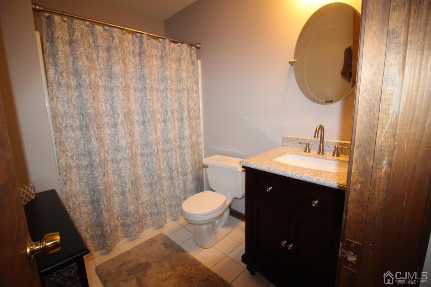 26 Homestead Road Edison, NJ 08820 - Photo 25 of 34 a bathroom with a sink and a mirror