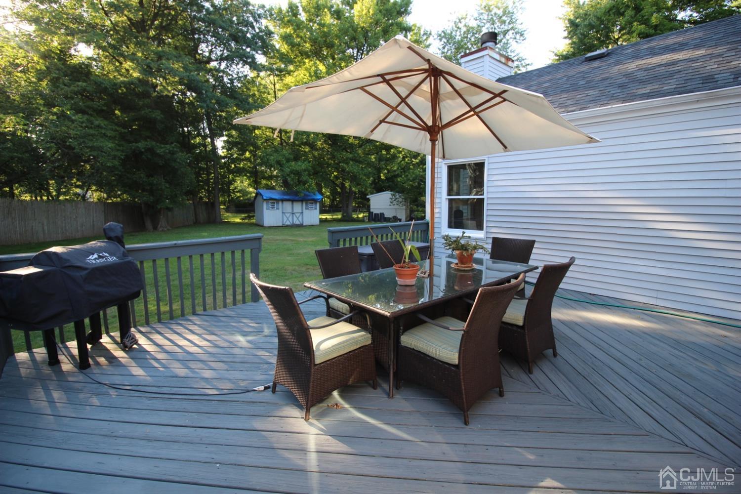 26 Homestead Road Edison, NJ 08820 - Photo 27 of 34 a view of a patio with table and chairs under an umbrella