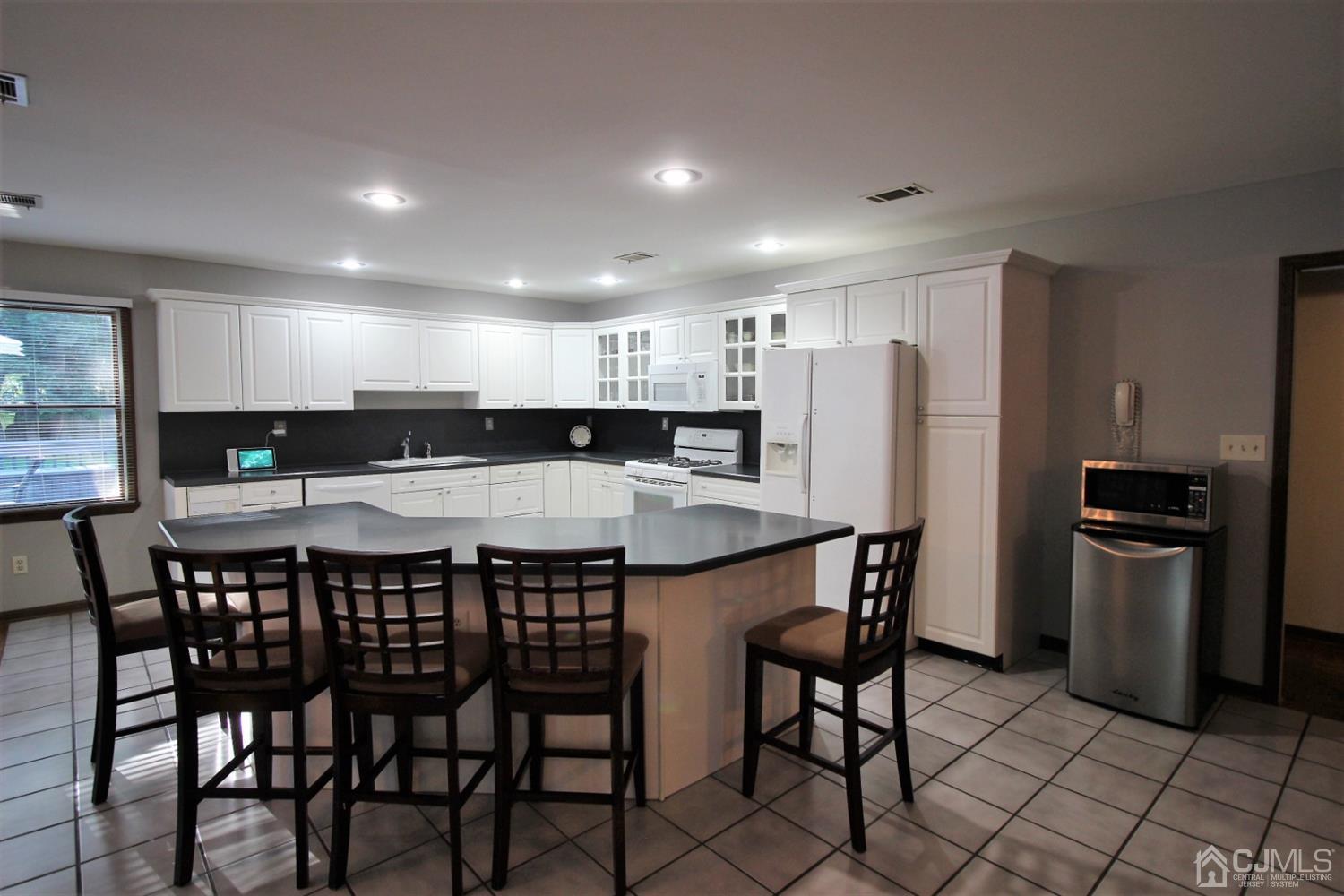 26 Homestead Road Edison, NJ 08820 - Photo 7 of 34 a kitchen that has a table and chairs in it