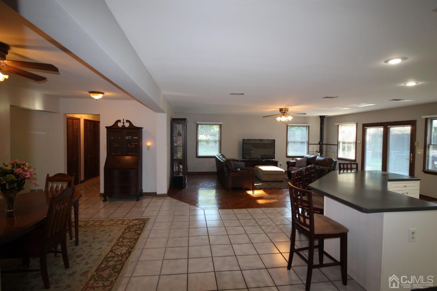 26 Homestead Road Edison, NJ 08820 - Photo 8 of 34 a living room with couches a table and a refrigerator
