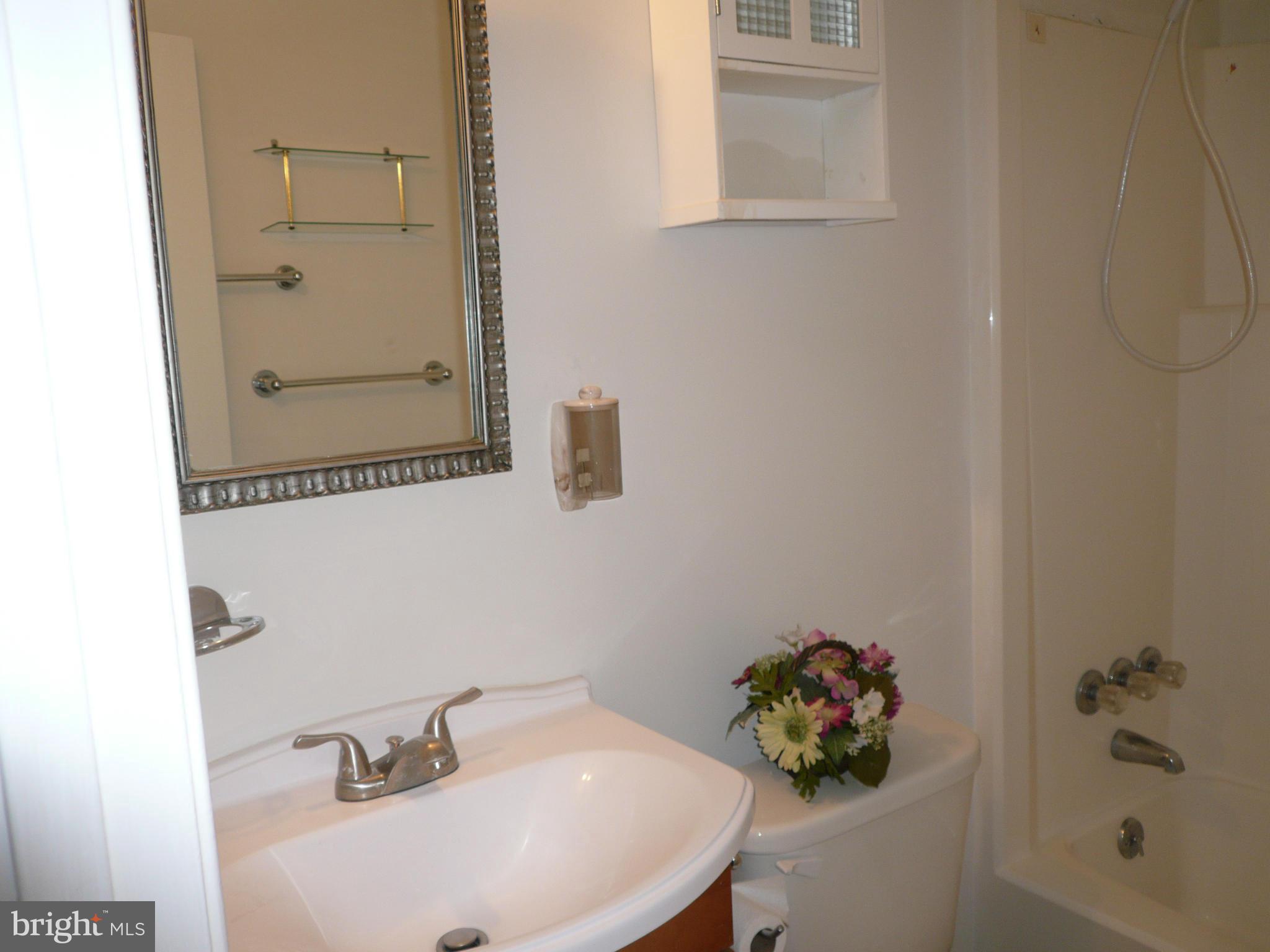 8512 Contee Road Laurel, MD 20708 - Photo 14 of 20 a bathroom with a sink and a mirror