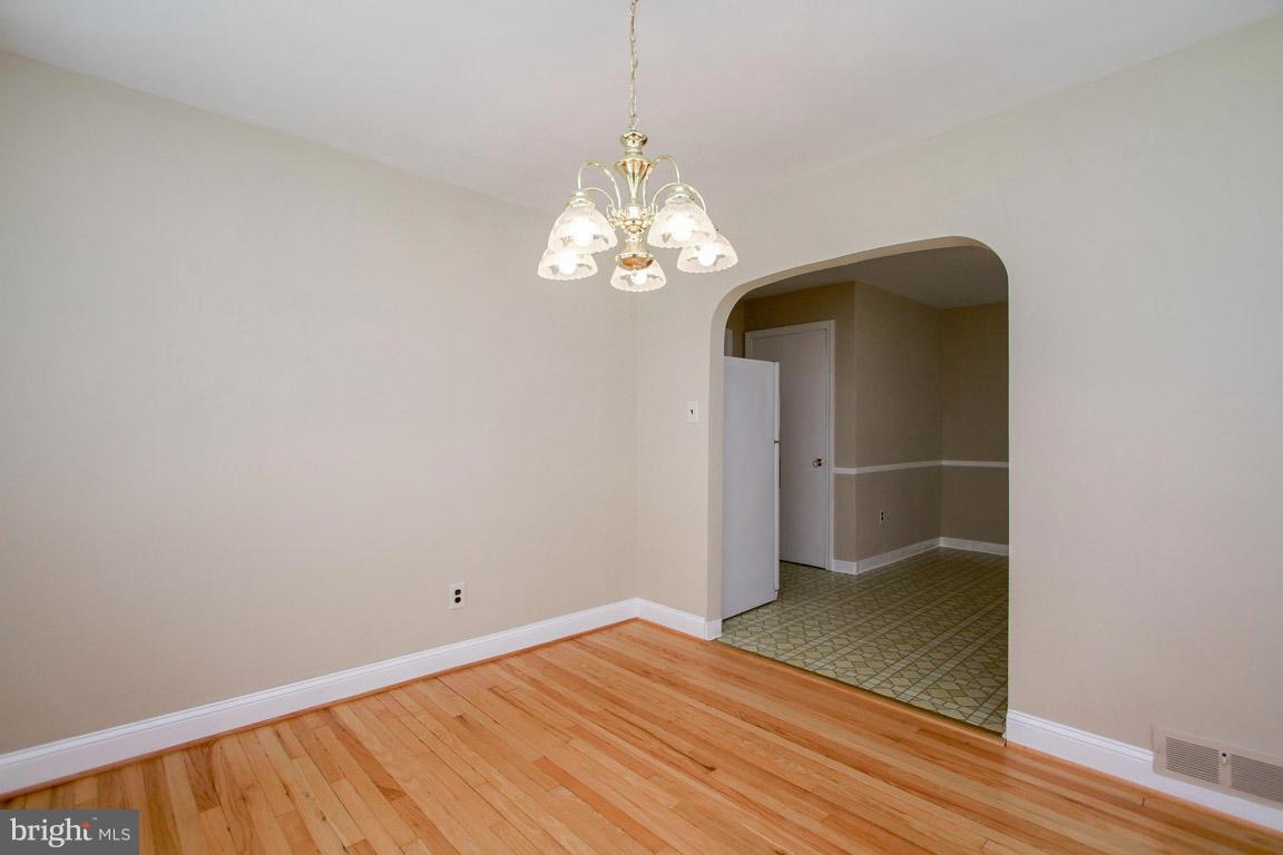 1402 Willow Oak Road Edgewood, MD 21040 - Photo 22 of 30 a view of a hallway with wooden floor and a chandelier