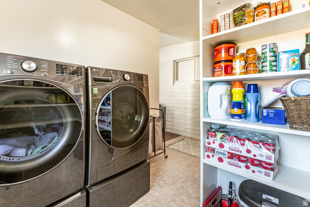 1619 Davis Drive Layton, UT 84041 - Photo 22 of 27 Laundry area featuring tile flooring, built-in shelving, and a white brick-patterned wall