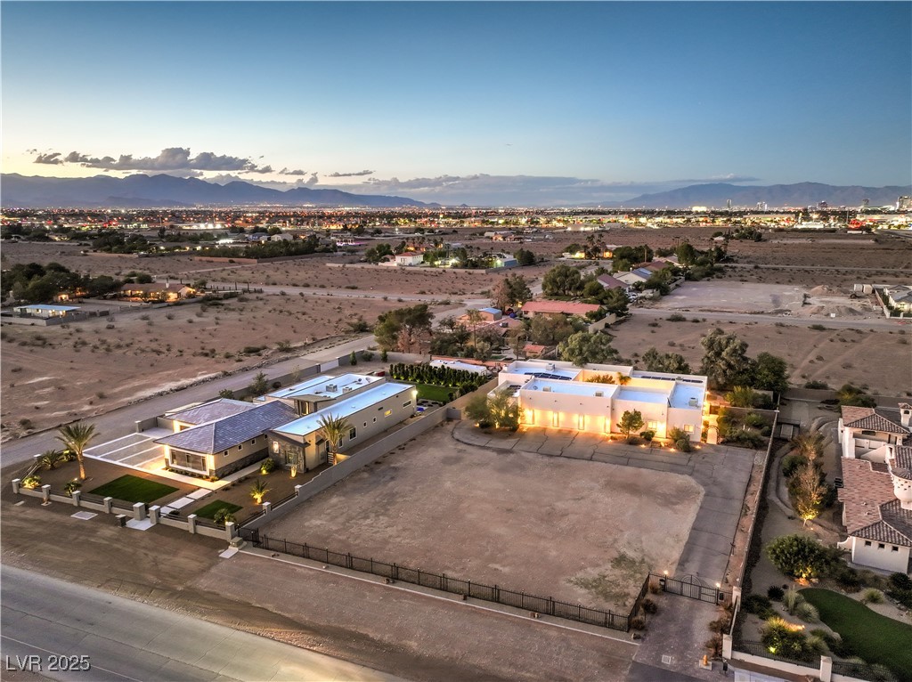 3910 West Pebble Road Las Vegas, NV 89139 - Photo 53 of 59 Aerial view at dusk of a mountain view, view of desert landscape, and a rural view