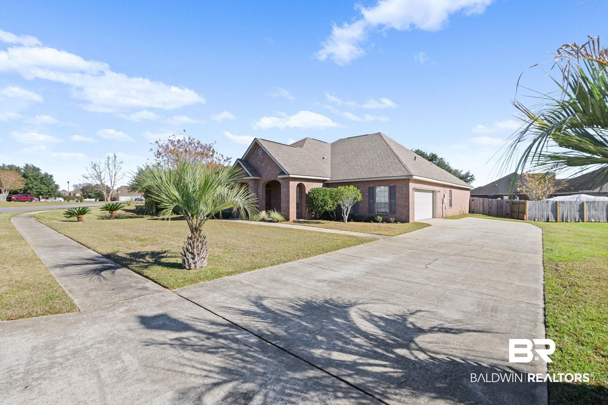 25234 Fairfax Road Daphne, AL 36526 - Photo 5 of 45 View of front facade featuring driveway, brick siding, an attached garage, and a shingled roof