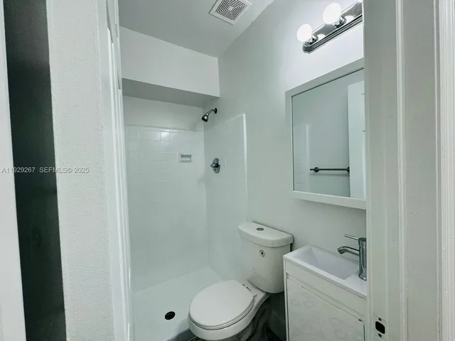 a front view of a house with a basket ball court and a garage