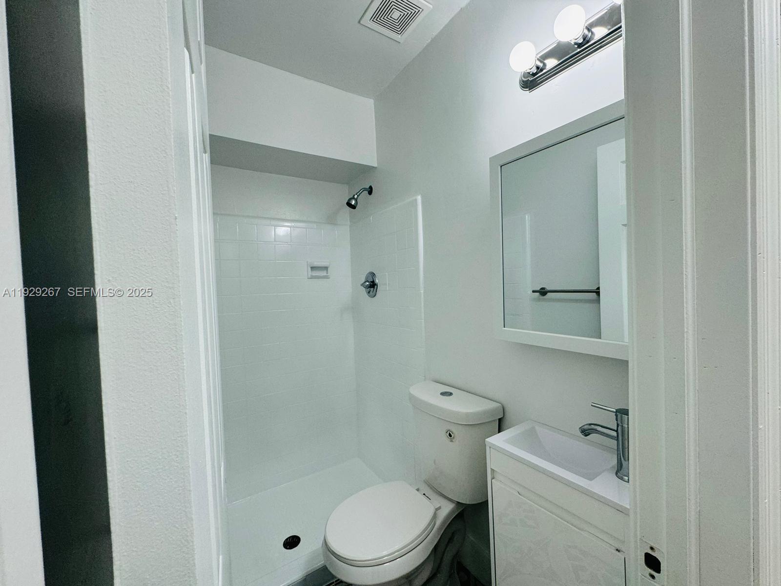 2940 West Flagler Street, Unit 4 Miami, FL 33135 - Photo 12 of 13 a white toilet sitting next to a bathroom sink