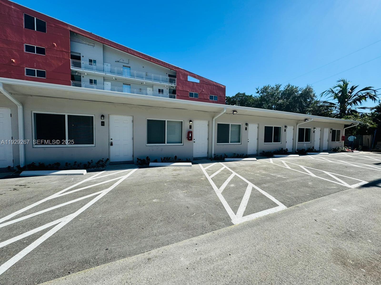2940 West Flagler Street, Unit 4 Miami, FL 33135 - Photo 13 of 13 a front view of a house with a basket ball court and a garage