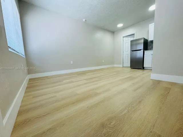 a view of an empty room with a fireplace