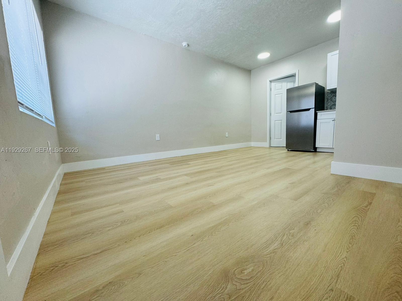 2940 West Flagler Street, Unit 4 Miami, FL 33135 - Photo 3 of 13 a view of an empty room with a fireplace