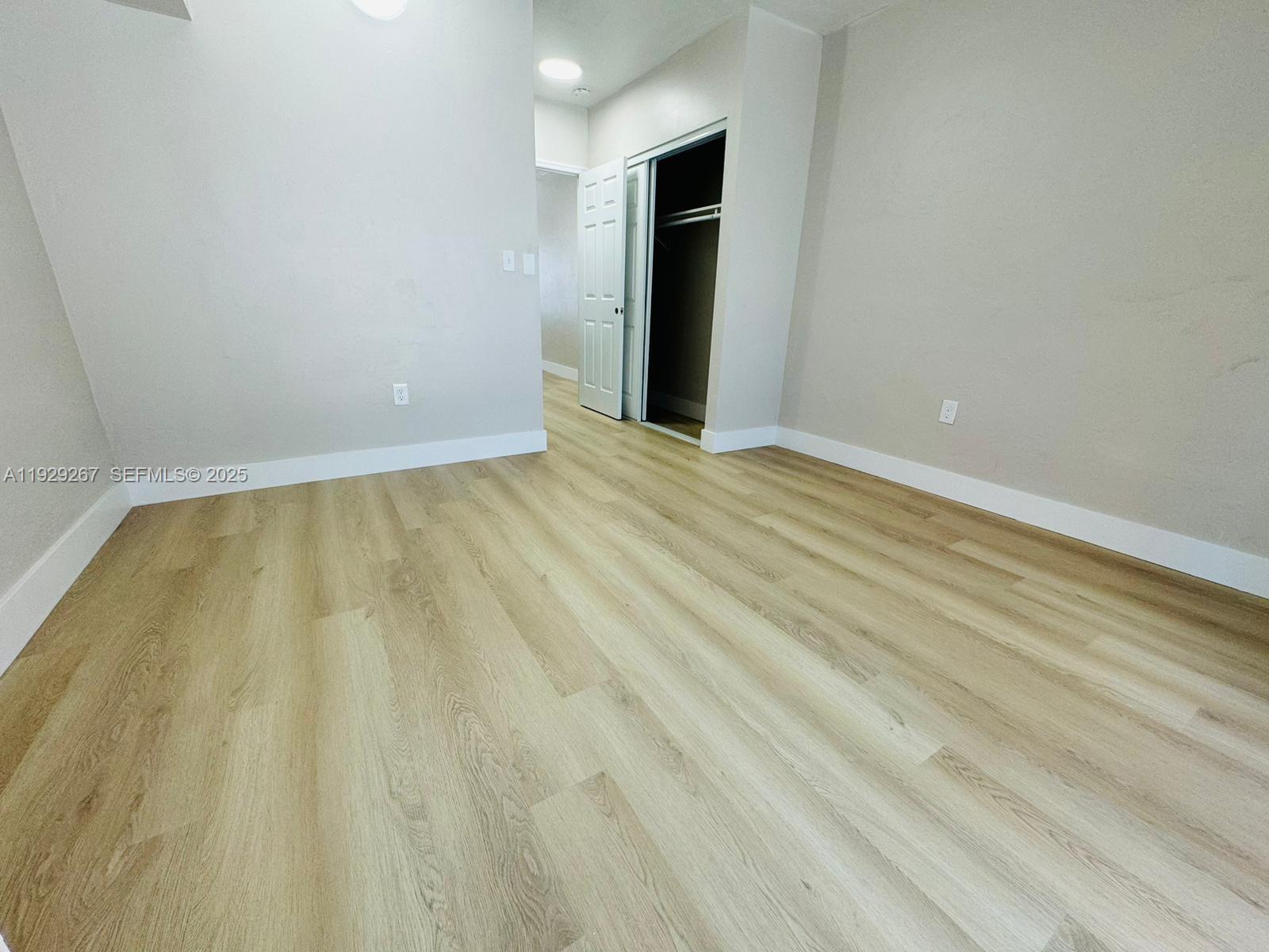 2940 West Flagler Street, Unit 4 Miami, FL 33135 - Photo 8 of 13 a view of an empty room with wooden floor