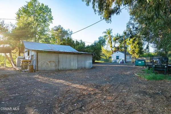 a view of a house with a tree and a yard