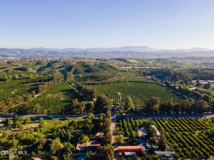 an aerial view of a residential houses with outdoor space and swimming pool