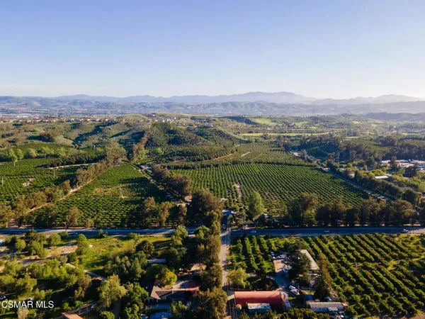 an aerial view of a residential houses with outdoor space and swimming pool