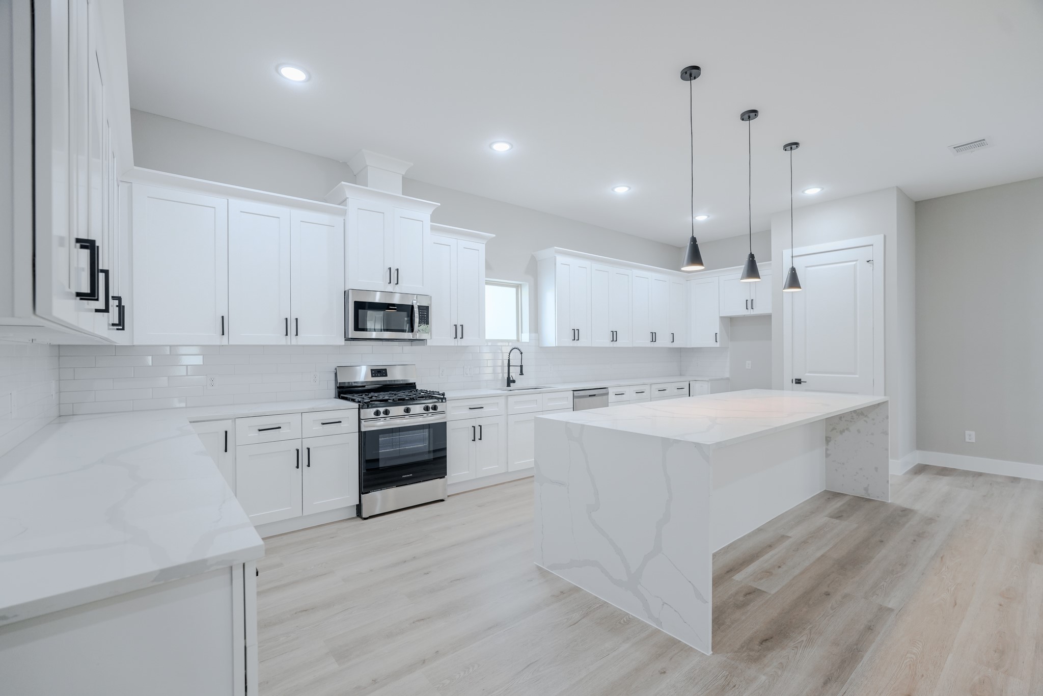 2618 Piemonte Avenue Cir Spring Spring, TX 77388 - Photo 16 of 50 a large kitchen with cabinets wooden floor and stainless steel appliances