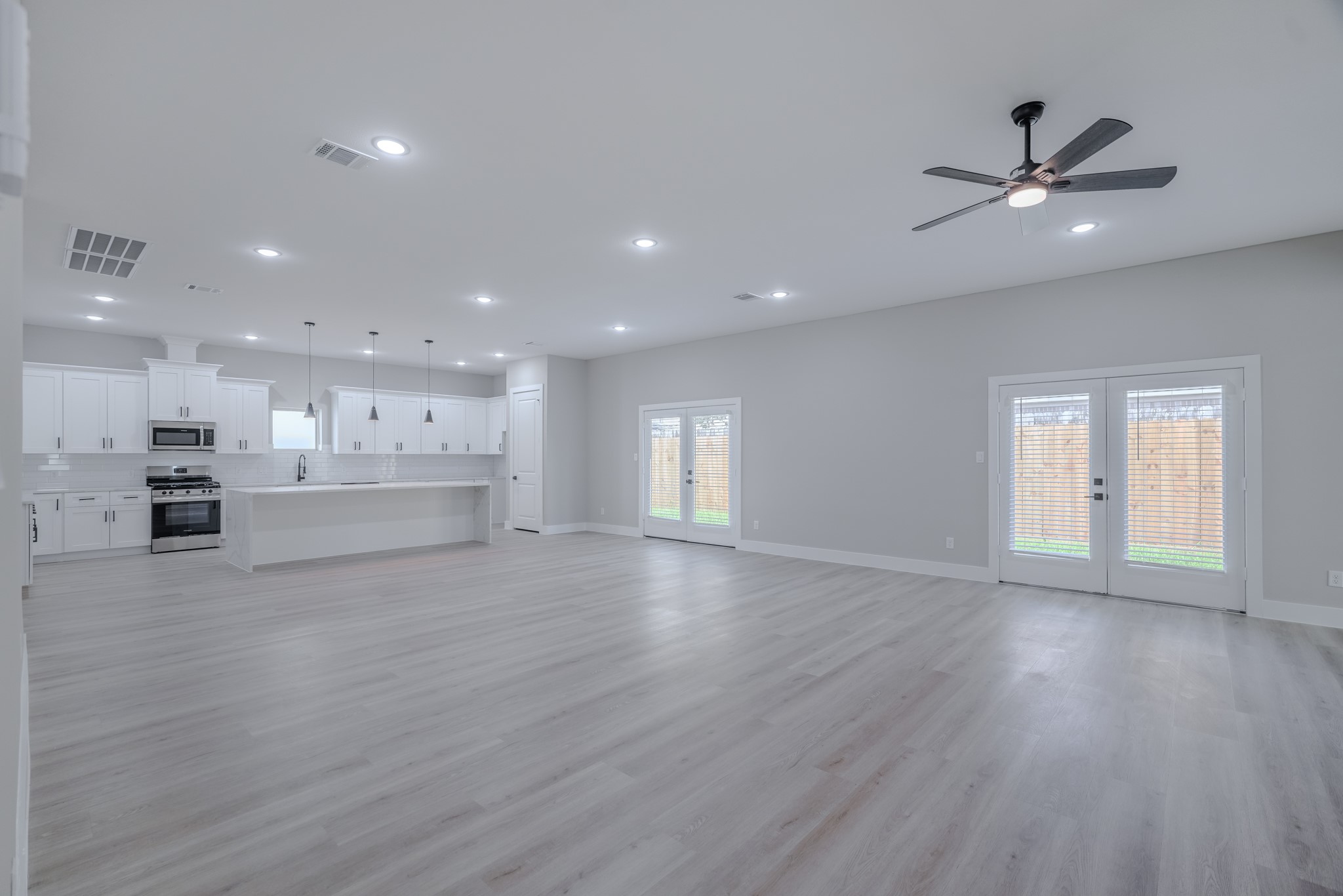 2618 Piemonte Avenue Cir Spring Spring, TX 77388 - Photo 6 of 50 a view of an empty room with wooden floor and kitchen view