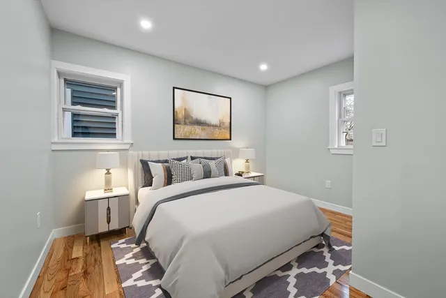 a bedroom with a bed and a painting on the wall