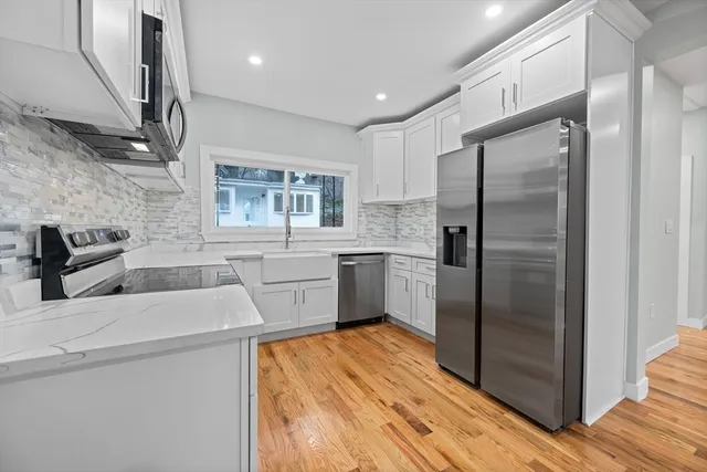a kitchen with a refrigerator sink and cabinets