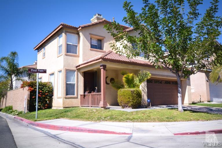 a front view of house with a garden
