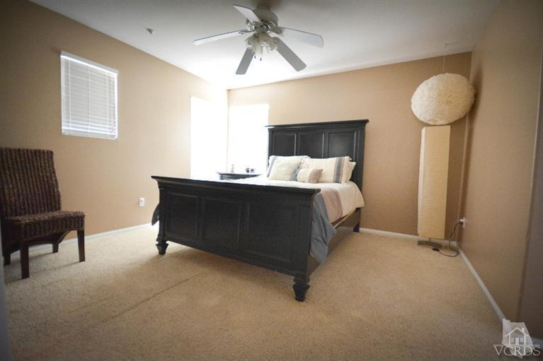 843 Pivot Point Way Oxnard, CA 93035 - Photo 14 of 21 a bedroom with a bed and a chandelier