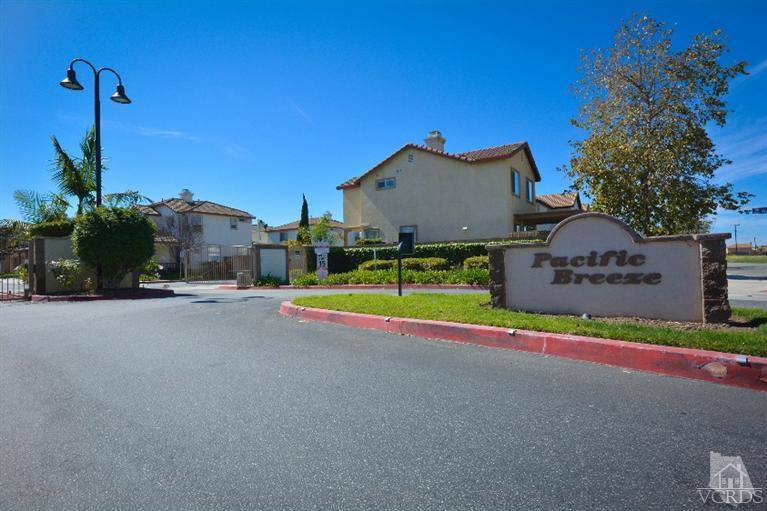 843 Pivot Point Way Oxnard, CA 93035 - Photo 20 of 21 a view of a house with a swimming pool and a yard