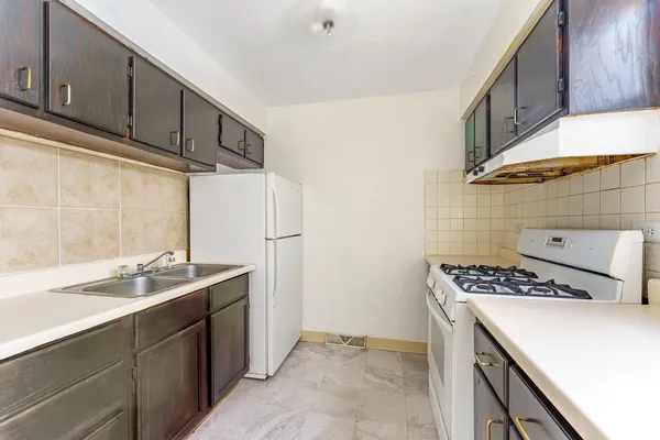 a kitchen with stainless steel appliances a sink stove and cabinets