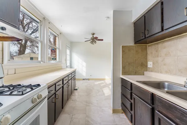 a kitchen with a sink and a stove top oven