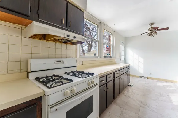 a kitchen with a stove and cabinets