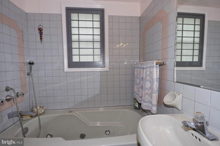 2105 Hanover Street Silver Spring, MD 20910 - Photo 2 of 23 a white bath tub sitting next to a white sink