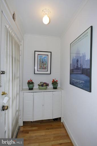 2105 Hanover Street Silver Spring, MD 20910 - Photo 11 of 23 a view of an empty room with wooden floor and wall painting