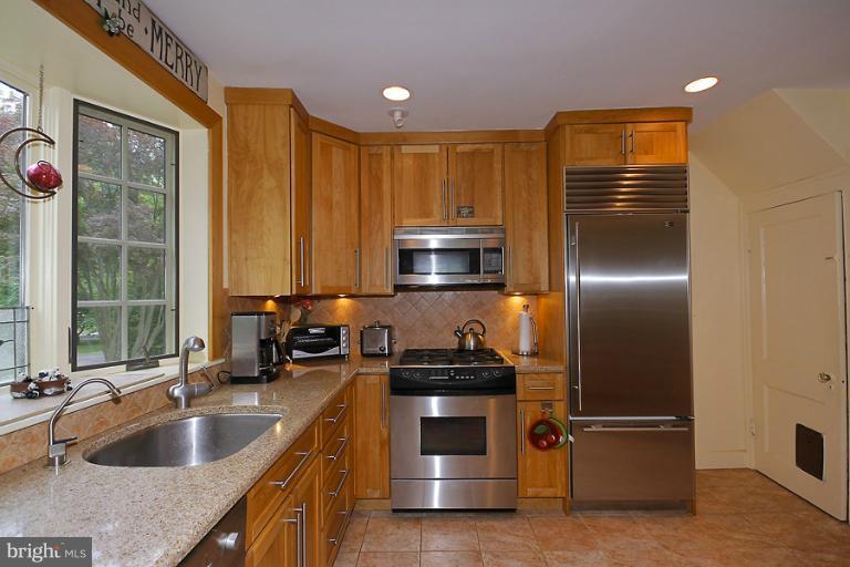 2105 Hanover Street Silver Spring, MD 20910 - Photo 13 of 23 a kitchen with kitchen island granite countertop a sink stainless steel appliances and cabinets