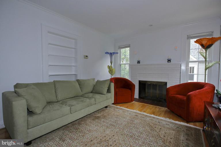 2105 Hanover Street Silver Spring, MD 20910 - Photo 21 of 23 a living room with furniture a flat screen tv and a fireplace