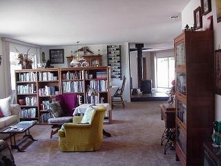 8900 Chalk Hill Road Healdsburg, CA 95448 - Photo 7 of 11 a living room with furniture a bookshelf and a window