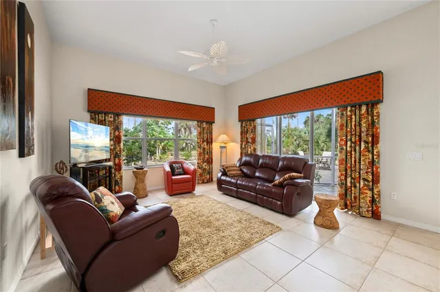 a spacious bedroom with a bed a dresser and a chandelier