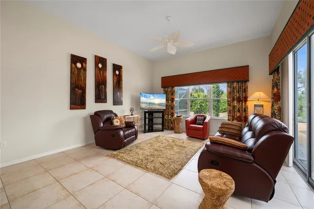 a bedroom with a bed window and a chandelier
