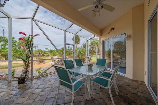 a view of a house with swimming pool and sitting area