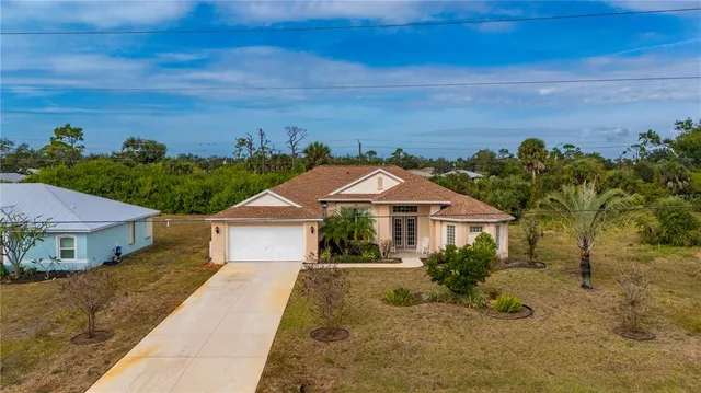 an aerial view of a house with a yard