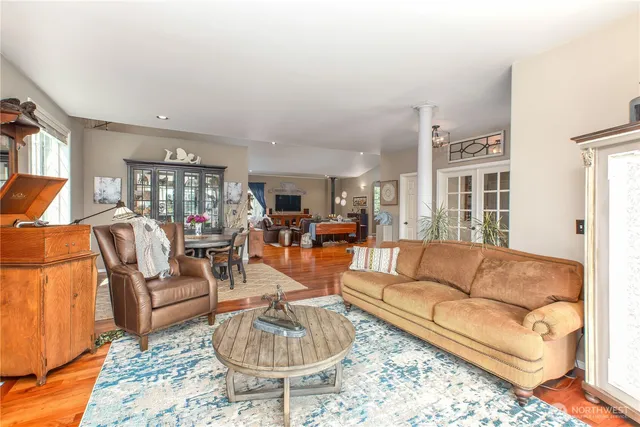 a living room with furniture potted plant and a rug