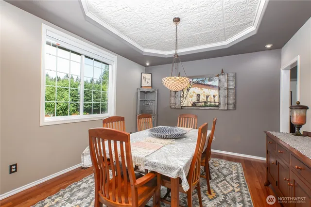 a dining room with furniture a chandelier and window
