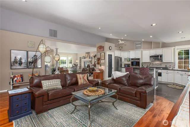 a living room with furniture kitchen view and a table