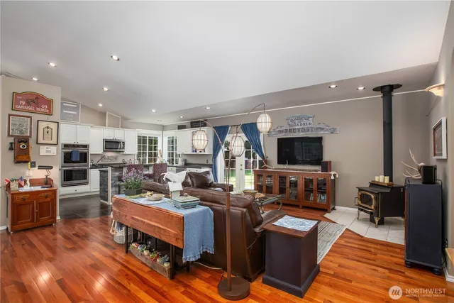 a living room with furniture a flat screen tv and kitchen view