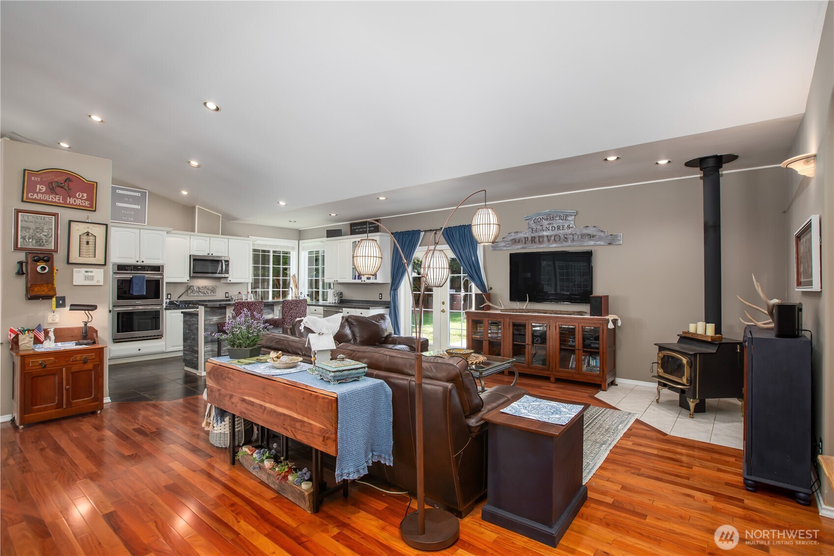29216 39th Avenue South Roy, WA 98580 - Photo 19 of 38 a living room with furniture a flat screen tv and kitchen view