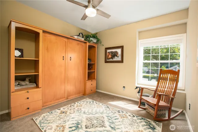 a view of a bedroom with furniture and windows