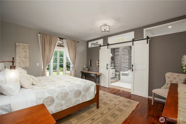 a bedroom with a bed and a large window