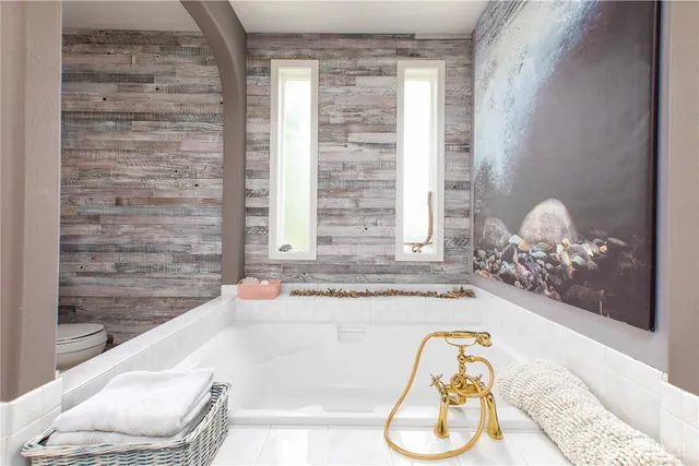 a bath tub sitting next to a window