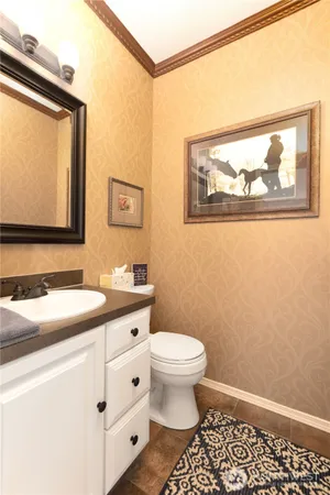 a bathroom with a toilet a sink and mirror