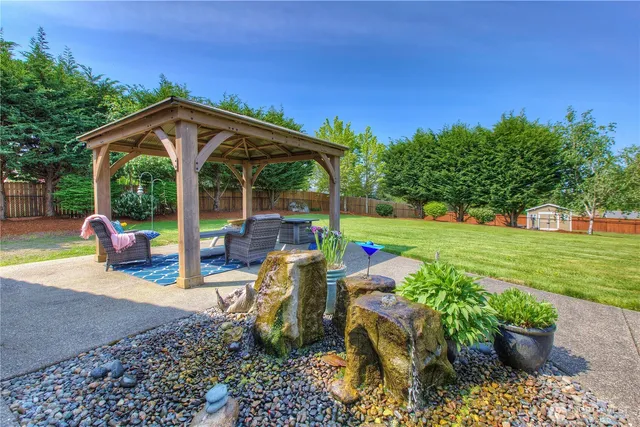 a view of a house with backyard porch and sitting area