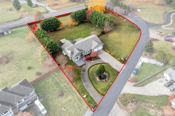 an aerial view of a house a garden and a fire pit