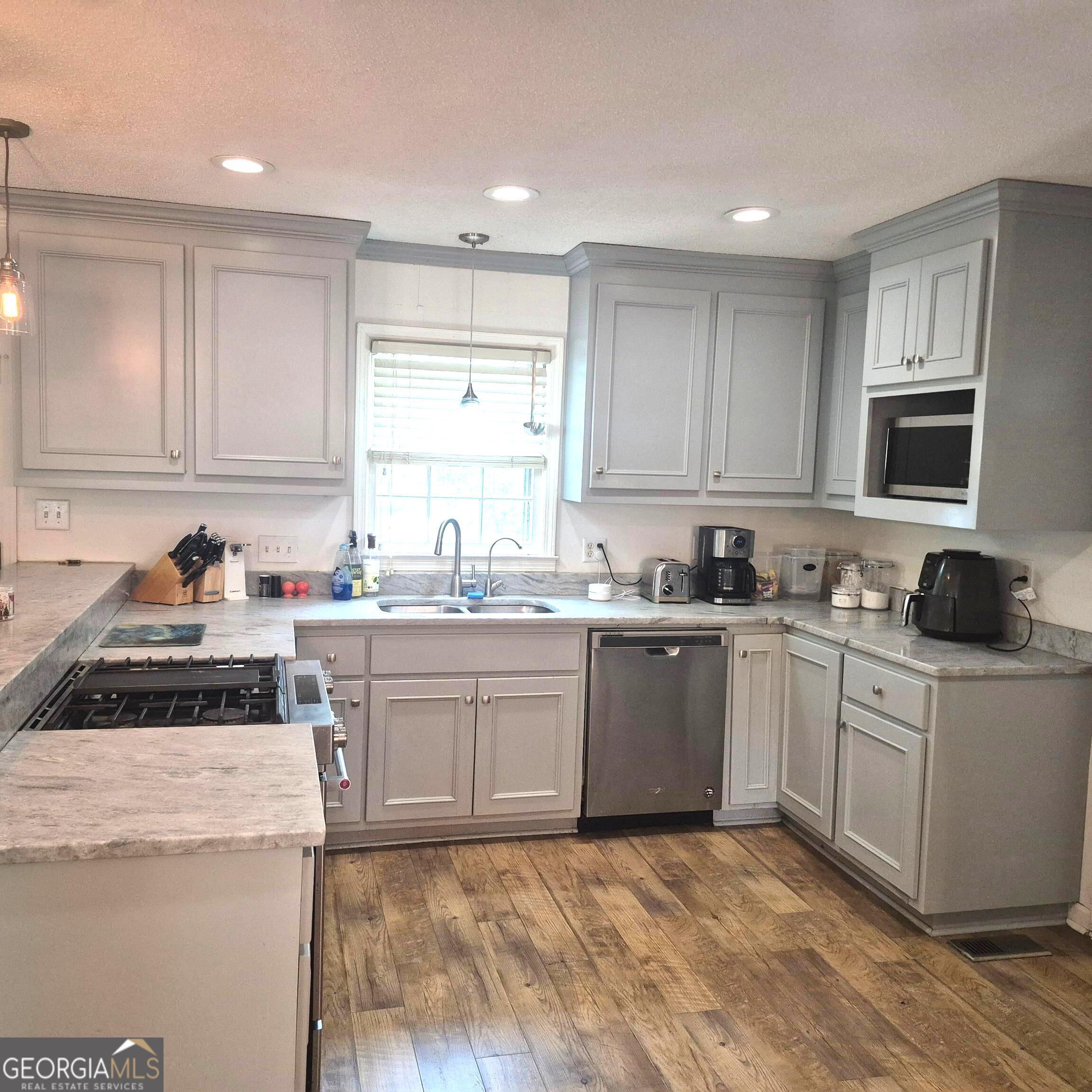 930 Hill Place Macon, GA 31210 - Photo 11 of 34 a large kitchen with granite countertop a sink a stove a microwave and cabinets